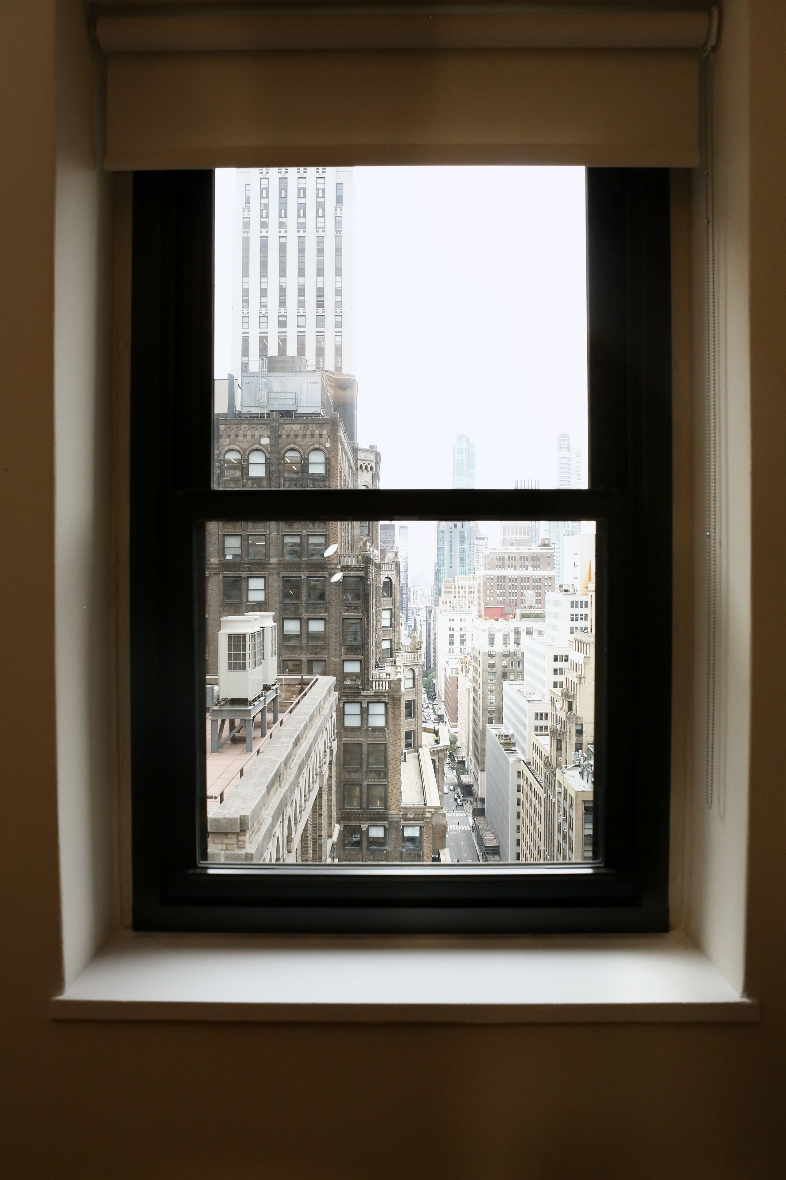 An office window looking out on the towers of Midtown Manhattan.